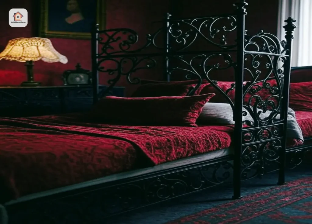Gothic bed with red bedding, vintage lace lamp, and dark framed portrait in a dim room