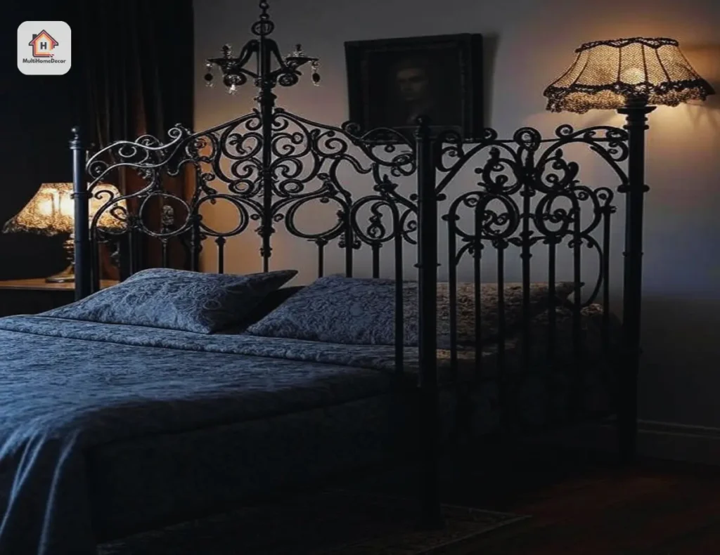 Gothic black iron bed with dark bedding, small chandelier, and soft lamp light in a dim room.